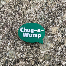 Load image into Gallery viewer, 1 inch tall, rubber Croc charm of a dark green speech bubble that says "Chug-a-Wump" sitting on grey, speckled stone.