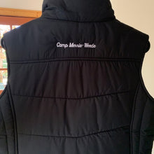 Load image into Gallery viewer, Back of black vest says &quot;Camp Merrie-Woode&quot; in white cursive lettering below across the shoulders.
