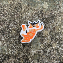 Load image into Gallery viewer, 1 inch tall, rubber Croc charm of the orange/tan colored Tajar - forest creature who is part tiger, badger, and jaguar. The Tajar charm is sitting on grey, speckled stone.
