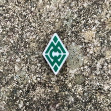Load image into Gallery viewer, 1 inch tall, rubber Croc charm of Camp Merrie-Woode&#39;s diamond logo, which is the letters C,M,W in green on top of a white diamond shape.
