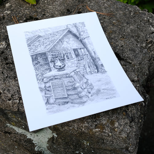 Picture of a sketch showing the camp bell on top of stone pillar. Bell sits in front of an office with side windows and outdoor stairs. Stone pillar has a plaque signifying how the bell is dedicated to 
