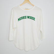 Load image into Gallery viewer, A white, 3/4 sleeve t-shirt that says &quot;Merrie-Woode&quot; across chest in green lettering hanging on a wooden hanger. 
